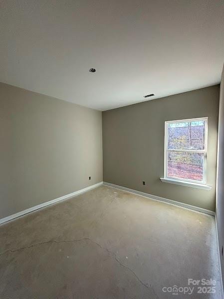 empty room with concrete flooring