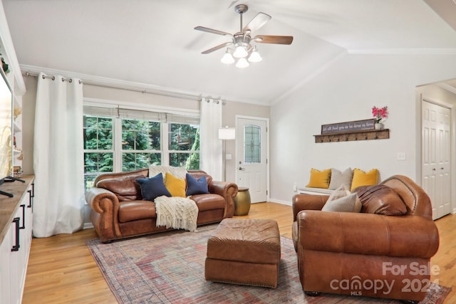 living room featuring hardwood / wood-style flooring, ceiling fan, crown molding, and vaulted ceiling