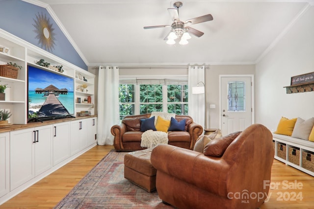 living room featuring crown molding, light hardwood / wood-style flooring, ceiling fan, and vaulted ceiling