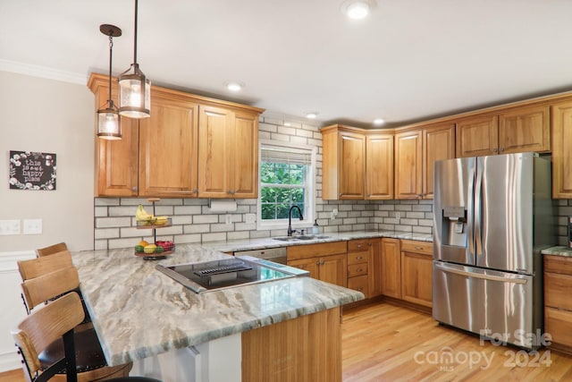 kitchen with kitchen peninsula, stainless steel fridge with ice dispenser, a kitchen bar, and decorative light fixtures