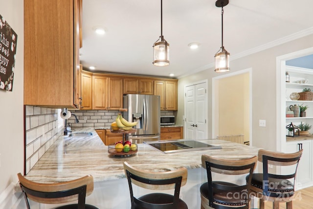 kitchen featuring a kitchen breakfast bar, sink, decorative backsplash, kitchen peninsula, and stainless steel appliances