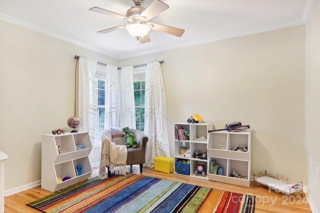 playroom with hardwood / wood-style flooring, ceiling fan, and crown molding