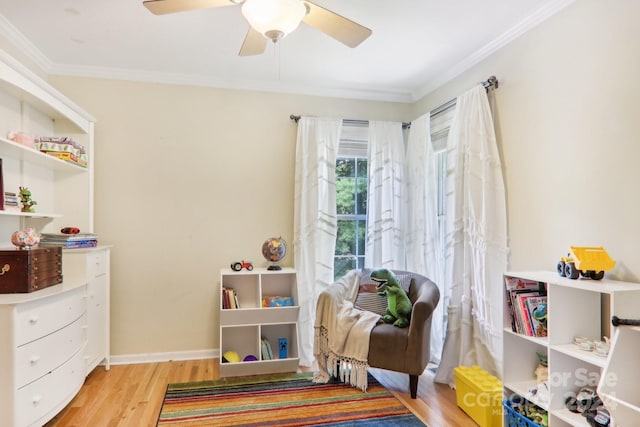 interior space with light hardwood / wood-style flooring, ceiling fan, and crown molding