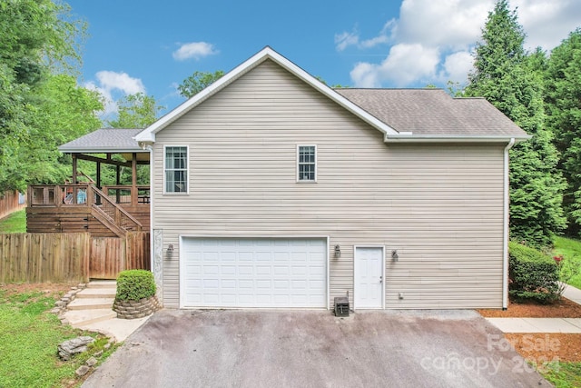 view of side of property with a garage and central air condition unit