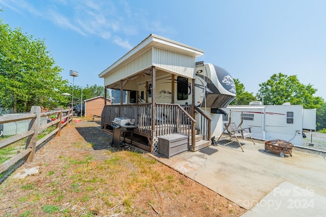 view of front of property with a storage shed and an outdoor fire pit