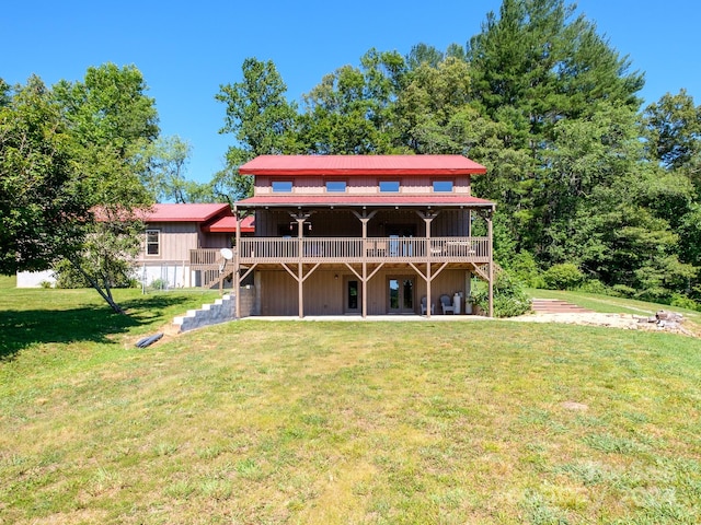 back of property featuring a deck and a yard