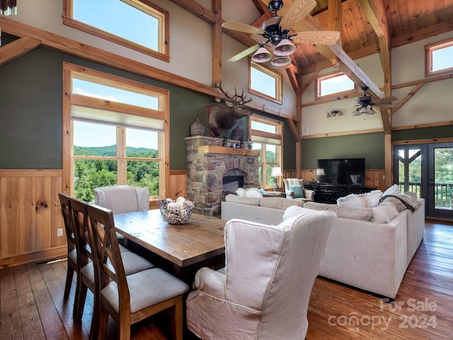 dining space with dark hardwood / wood-style flooring, plenty of natural light, and high vaulted ceiling