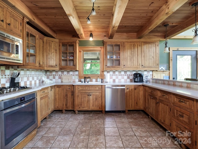 kitchen with wooden ceiling, appliances with stainless steel finishes, hanging light fixtures, beam ceiling, and dark tile patterned floors