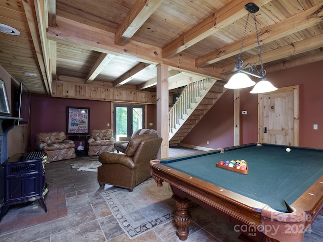 recreation room with wood ceiling, a wood stove, billiards, and beamed ceiling