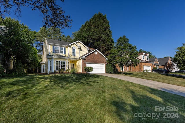 front facade with a front yard and a garage