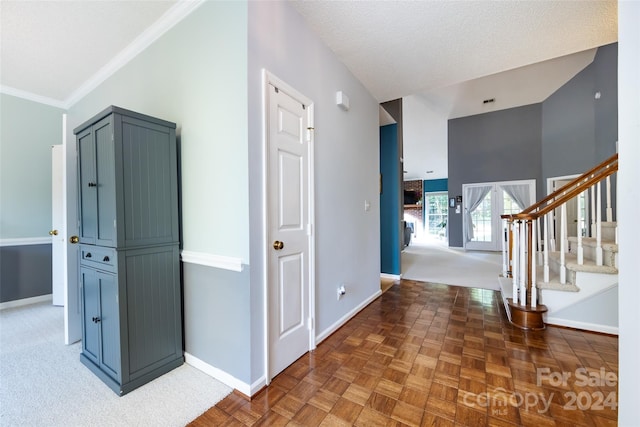 hall featuring a textured ceiling, parquet floors, and crown molding