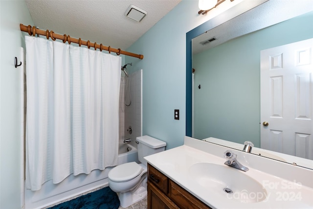 full bathroom with vanity, shower / bath combination with curtain, a textured ceiling, and toilet