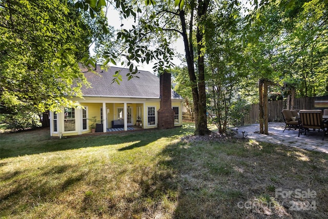 exterior space with a lawn and a patio area