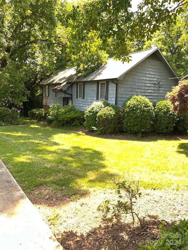 view of side of home featuring a yard