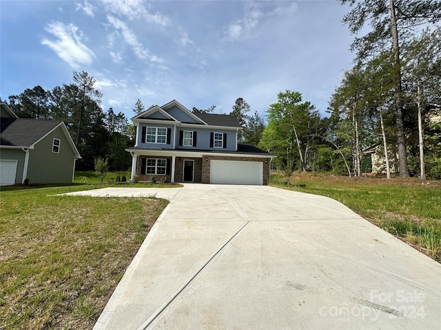 view of front of house featuring a garage and a front yard