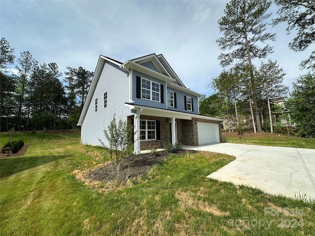 view of front of house featuring a garage and a front lawn