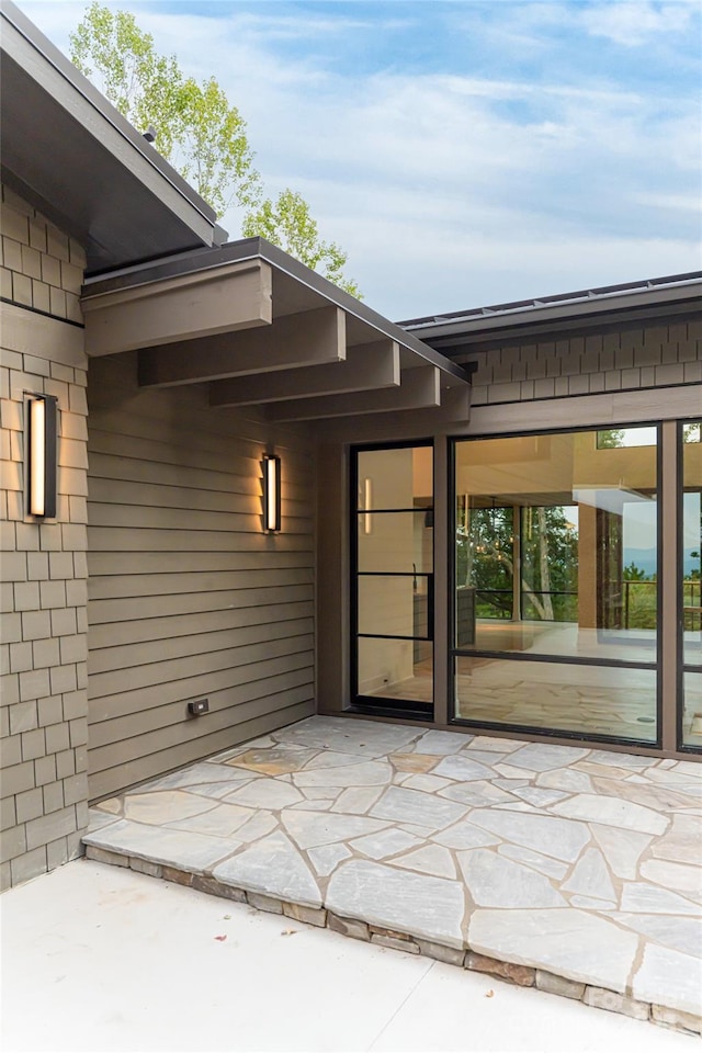 doorway to property with a patio area