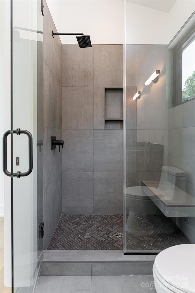 full bathroom with a stall shower, tile patterned flooring, and toilet