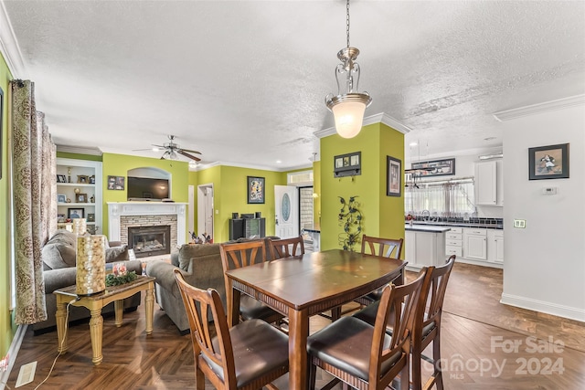 dining area featuring a textured ceiling, dark parquet floors, and built in features