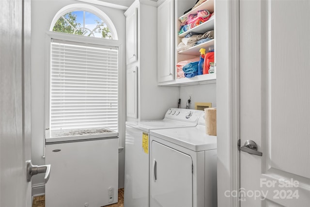 washroom featuring cabinets and independent washer and dryer