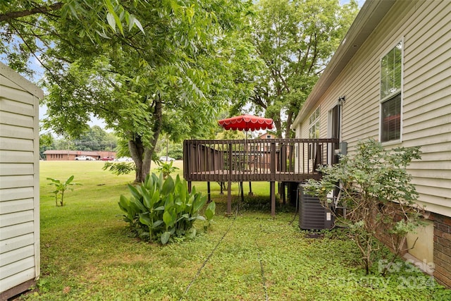 view of yard with a deck and central AC