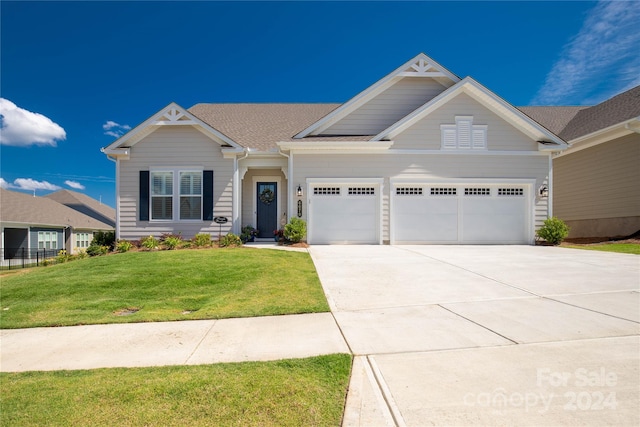 craftsman-style house with a front lawn and a garage