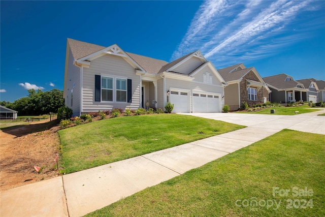 view of front of home with a front yard and a garage