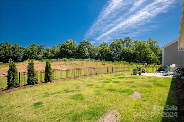 view of yard with a rural view and a patio