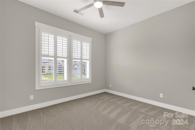 spare room featuring carpet flooring and ceiling fan