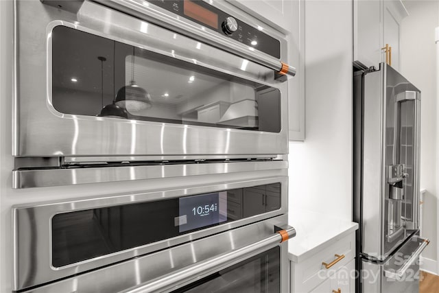 interior details featuring white cabinets and stainless steel appliances