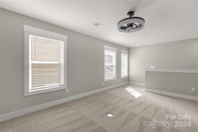 unfurnished room with light carpet