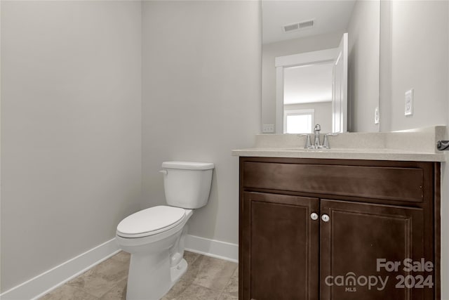 bathroom featuring vanity, toilet, and tile patterned floors