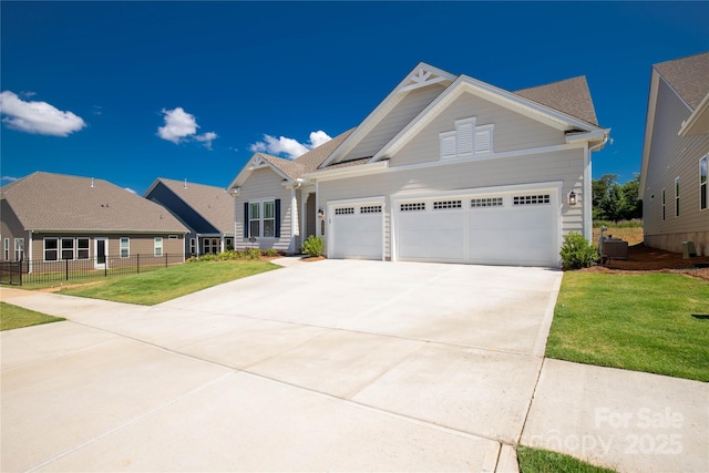 view of front facade featuring a garage, driveway, a front yard, and fence