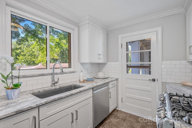 kitchen featuring sink, light stone countertops, crown molding, white cabinetry, and appliances with stainless steel finishes