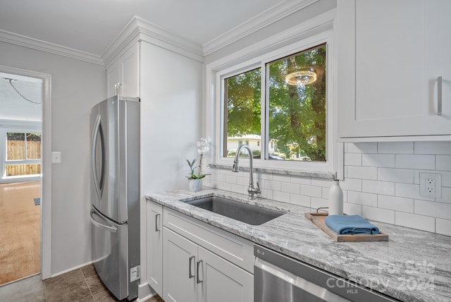 kitchen with white cabinetry, light stone countertops, stainless steel appliances, and sink