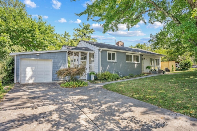 ranch-style house featuring a front yard and a garage