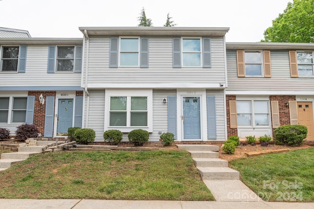 view of property featuring a front lawn