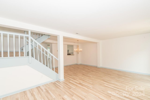 interior space featuring hardwood / wood-style floors and an inviting chandelier