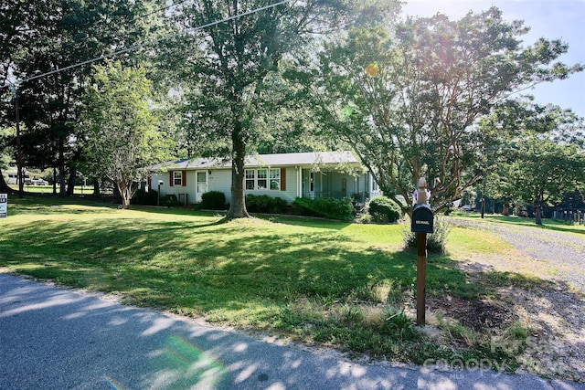 ranch-style home with a front yard