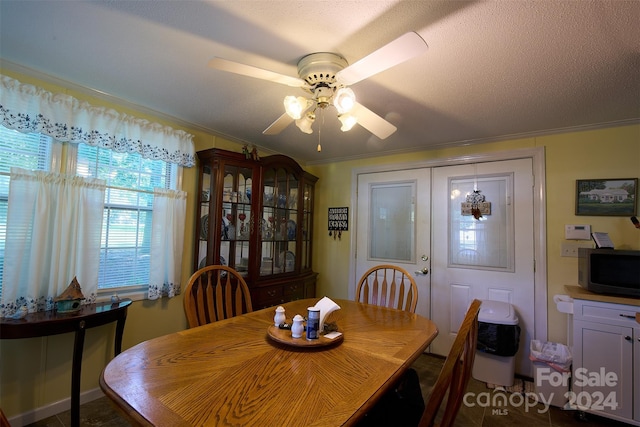 dining area featuring crown molding and ceiling fan