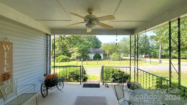 sunroom / solarium featuring ceiling fan