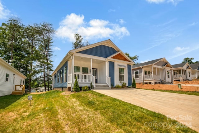 view of front of property with a front yard and a porch