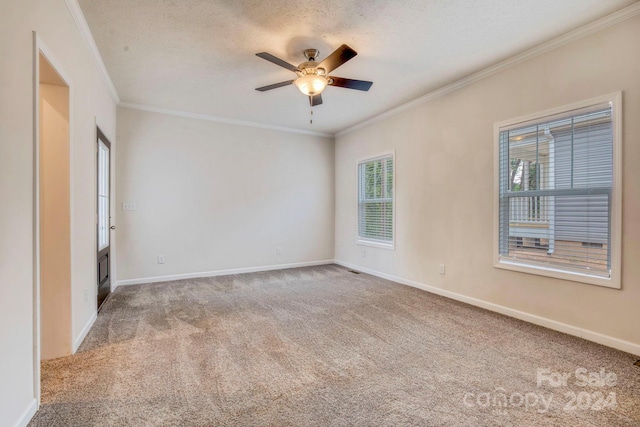 spare room featuring carpet floors, ceiling fan, crown molding, and a textured ceiling