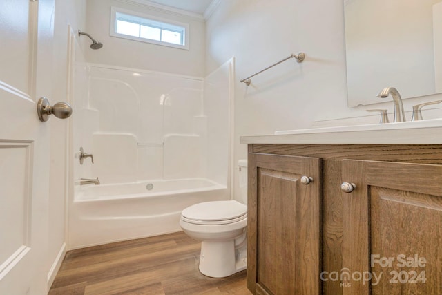 full bathroom with wood-type flooring, vanity, toilet, ornamental molding, and  shower combination