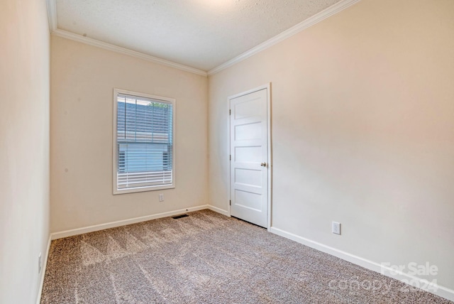 carpeted empty room with a textured ceiling and crown molding