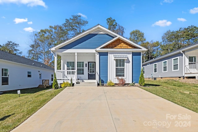 view of front facade with a front yard and covered porch