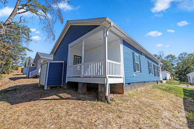 view of side of home featuring a lawn