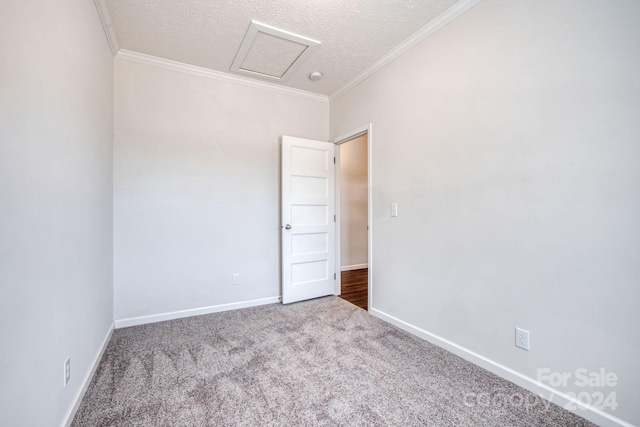 carpeted spare room featuring a textured ceiling and ornamental molding