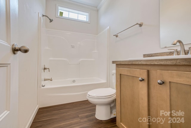 full bathroom featuring toilet, bathing tub / shower combination, wood-type flooring, ornamental molding, and vanity