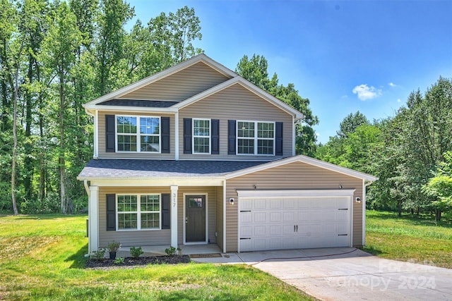 front of property with a garage and a front lawn